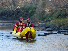Firefighters use a raft as they search Monday for a missing woman along the banks of the south branch of the Thames River near Wellington Road in London. Heidi Holm, 77, was last seen at Wellington and Frank Place about 11 p.m. Sunday. An unidentified body was found Monday. (CRAIG GLOVER, The London Free Press)