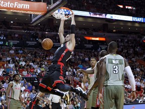 Raptors’  Jonas Valanciunas dunks during Sunday’s game in Miami. Big V has been a fairly consistent scorer this season, but the team has struggled offensively in recent games. (AP/PHOTO)