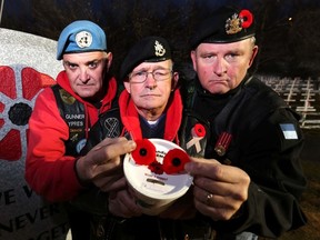 L-R, 3rd Canadian Army Veterans Motorcycle Unit members Tom McMahon, John Kirk and Darrel Sundholm are not pleased to hear of all the poppy box thefts happening in the city. The three had just finished taking part in the daily evening ceremony at the Field of Crosses Memorial Project along Memorial Dr. on Monday November 9, 2015. Darren Makowichuk/Calgary Sun/Postmedia Network