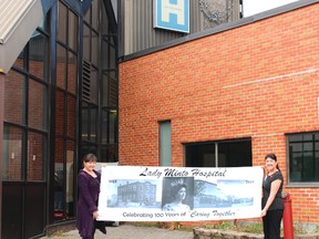 Sylvie Lvoie-Girard and Suzanne Gadoury hold the banner that will be on display to commemorate the historic occasion of 100 years of service of the Lady Minto Hospital to the Cochrane community.