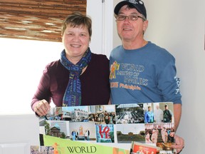 Nancy and Normand Bouvier hold up a poster with many photos which they took while on their visit to Philadelphia for the World Meeting of Families Congress.