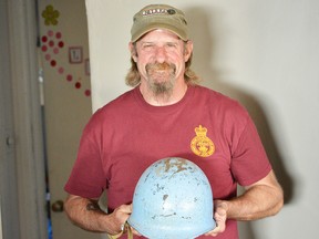 Gerry Brooks stands holding the blue helmet that he keeps on a shelf in his livingroom. The Petrolia man was a member of the Second Battalion of the Princess Patricia’s Canadian Light Infantry and was stationed in Croatia, serving two tour of duty during the crisis in Yugoslavia over 20 years ago. (Brent Boles/ Postmedia Network)