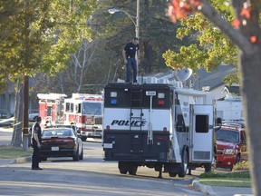 Police investigate the scene where a car caught fire with people inside in Orange, Calif., Monday, Nov. 9, 2015. (Jeff Gritchen/The Register via AP)