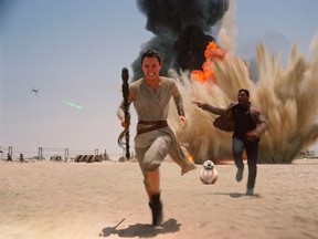 This photo provided by Disney shows Daisey Ridley as Rey, left, and John Boyega as Finn, in a scene from the new film, "Star Wars: The Force Awakens." (THE CANADIAN PRESS/AP, Film Frame/Disney/Lucasfilm)