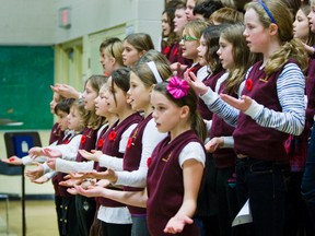 Students sing during the Remembrance Day ceremony at Maurice Cody Junior Public School in Toronto on Nov. 11, 2011. (Ernest Doroszuk/Toronto Sun)