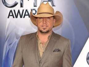 In this Nov. 4, 2015 file photo, Jason Aldean arrives at the 49th annual CMA Awards in Nashville, Tenn.  A representative for Aldean said Tuesday, Nov. 10, that the country star dressed as rapper Lil Wayne as a Halloween costume after a picture surfaced of him with what looks like a painted face and a wig with dreadlocks. (Photo by Evan Agostini/Invision/AP, File)