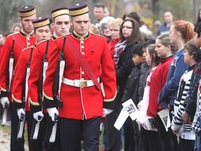 Schoolchildren look on as Royal Military College cadets march to stand vigil at the cenotaph in Cataraqui Cemetery in Kingston, Ont. on Tuesday, Nov. 10, 2015 for a pre-Remembrance Day ceremony in the cemetery's military section. Michael Lea/The Whig-Standard/Postmedia Network