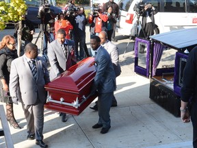 The casket of 9-year-old Tyshawn Lee is carried into St. Sabina Church, Tuesday, Nov. 10, 2015 in Chicago. The elementary school student was shot in the head Nov. 2, after police say he was lured into an alley and executed because of his father's gang connections. (Brian Jackson/Chicago Sun-Times via AP)