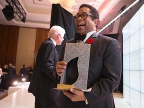 Andre Alexis stands on stage after winning the Giller Prize for his novel "Fifteen Dogs" during a gala ceremony in Toronto on Tuesday November 10, 2015. The book - about 15 dogs gifted by gods with human traits - was praised by jury members as an "insightful and philosophical meditation on the nature of consciousness." THE CANADIAN PRESS/Chris Young