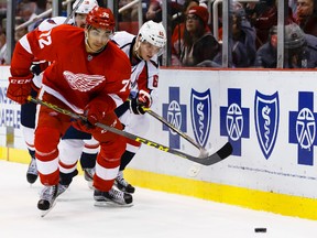 Nov 10, 2015; Detroit, MI, USA; Detroit Red Wings center Andreas Athanasiou (72) and Washington Capitals left wing Andre Burakovsky (65) battle for the puck in the second period at Joe Louis Arena. Mandatory Credit: Rick Osentoski-USA TODAY Sports