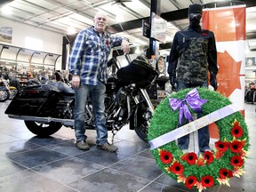 Greg Erixon, dealer principal at the Rock Harley-Davidson, shows off a Remembrance Day wreath in his show room in Sudbury on Tuesday. Gino Donato/Sudbury Star/Postmedia Network