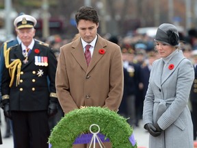 Prime Minister Justin Trudeau and Sophie Gregoire-Trudeau look on after placing a wreath during the Remembrance Day ceremony in Ottawa on Wednesday, Nov. 11, 2015. Gov.-Gen. David Johnston looks on at left. THE CANADIAN PRESS/Adrian Wyld