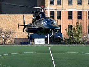 New Jersey Devils owner Josh Harris' private helipopter lands at a Newark school's soccer field last year. (YouTube)