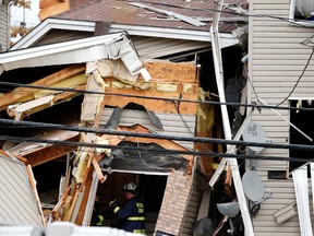 Officials investigate the inside of a house explosion, Wednesday, Nov. 11, 2015, in Elizabeth, N.J.  (AP/Julio Cortez)
