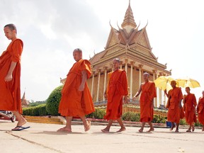 Monks proceed single-file to lunch at Udon Monastery in central Cambodia. (STEVE MACNAULL/Special to Postmedia Network)