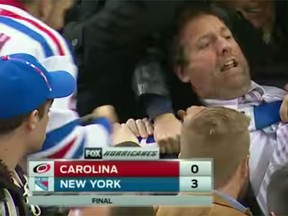 Fans grapple over a Henrik Lundqvist goalie stick on Tuesday at Madison Square Garden. (YouTube)