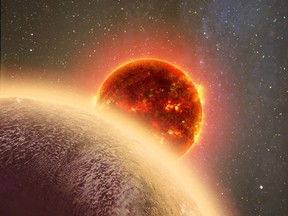 This artist’s conception made by Dana Berry of SkyWorks and provided by NASA on Nov. 6, 2015 shows GJ 1132b, foreground, a rocky planet similar to the Earth in size and mass, orbiting a red dwarf star. (Dana Berry/SkyWorks/NASA via AP)