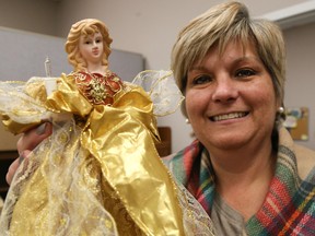 TIM MILLER/THE INTELLIGENCER
Volunteer and Information Quinte (VIQ) executive director Brenda Snider holds up a Christmas topper angel at VIQ's offices in Century Place on Wednesday. The topper was donated toward VIQ's Christmas Sharing Tree program which provides decorated Christmas trees to families in need.