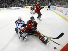 Minnesota Wild center Charlie Coyle (3) and Winnipeg Jets right wing Drew Stafford (12) fall as they chase the puck during the second period of an NHL hockey game in St. Paul, Minn., Tuesday, Nov. 10, 2015. (AP Photo/Ann Heisenfelt)