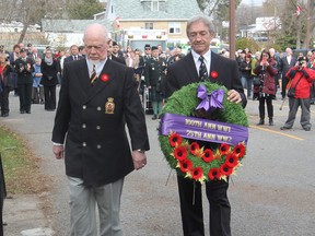 Don Cherry, left, and former NHLer Rick Smith place a wreath on a cenotaph at a Royal Canadian Legion branch at a Remembrance Day ceremony in Kingston. (Michael Lea/The Whig-Standard)