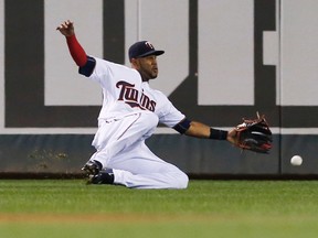 Minnesota Twins centre fielder Aaron Hicks makes a sliding attempt for a fly ball against the Kansas City Royals Friday, Oct. 2, 2015, in Minneapolis. (AP Photo/Jim Mone)