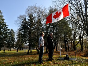 Mason Floyd (left) and Ian Gordon of Fire and Iron Custom Metal Work reflect near a new memorial commemorating The Battle of Vimy Ridge in London Ont. November 11, 2015. Fire and Iron was commissioned to create the monument, which was installed on Remembrance Day in a small park near the roundabout on Hale Street and Trafalger Street in east London. CHRIS MONTANINI\LONDONER\POSTMEDIA NETWORK