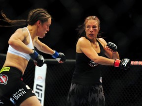 Valerie Letourneau (red) fights against Elizabeth Phillips in their Bantamweight bout at UFC 174 at Rogers Arena in Vancouver on June 14, 2014. (Anne-Marie Sorvin/USA TODAY Sports)