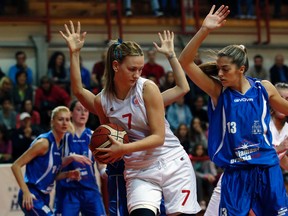 Red Star Belgrade player Natasa Kovacevic (centre) fights for the ball during a Serbian women's basketball league match in Belgrade on Wednesday, Nov. 11, 2015. (Darko Vojinovic/AP Photo)