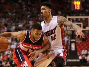 Garrett Temple of the Washington Wizards drives on Gerald Green of the Miami Heat during a preseason game at American Airlines Arena on October 21, 2015 in Miami, Florida. (Mike Ehrmann/Getty Images/AFP)