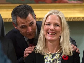 Hunter Tootoo, Minister of Fisheries, Oceans, and the Canadian Coast Guard speaks with Catherine McKenna, Minister of the Environment and Climate Change as they wait for a group photo, Wednesday Nov. 4, 2015 in Ottawa. Canada's new environment minister says the national target set by the Conservatives for cutting greenhouse gas emissions should be considered a floor for future action. THE CANADIAN PRESS/Justin Tang
