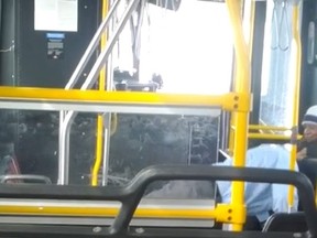 A video posted to YouTube appears to show an employee doing pushups on a bus while passengers watch. (Ian Byrne/YouTube)