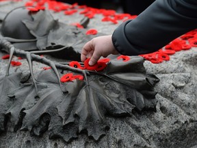 Poppies are placed on the Tomb of the Unknown Soldier at the National War Memorial following the Remembrance Day ceremony in Ottawa on Wednesday, November 11, 2015. THE CANADIAN PRESS/Sean Kilpatrick