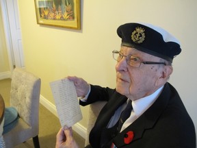 Bill Fitsell holds the page of a notebook that was used to acquire the name, rank and serial number of the survivors of a German U-boat that had been paralyzed by a depth charge from a nearby frigate and were picked up by the HMCS Outremont, on which Fitsell served near the end of the Second World War. (Patrick Kennedy/The Whig-Standard)