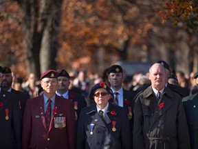 People observe a moment of silence during Wednesday?s Remembrance Day ceremony in London. (CRAIG GLOVER, The London Free Press)
