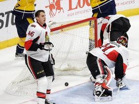 Senators defenceman Patrick Wiercioch (46) looks on as Nashville Predators'  Barret Jackman (5) celebrates with Colin Wilson (33) after Jackman scored during the third period of thier NHL hockey game Tuesday, Nov. 10, 2015, in Nashville, Tenn.  At front left is Ottawa's Patrick Wiercioch. (AP Photo/Mark Humphrey)