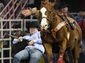 Tanner Milan takes part in the first go-round of steer wrestling during Day 1 of the Canadian Finals Rodeo at Rexall Place on Wednesday. (David Bloom, Edmonton Sun)