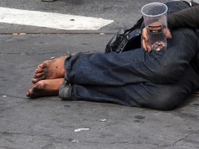 In this Friday, Sept. 4, 2015, file photo, a homeless man asks for money on 14th Street in New York. One app dots a map with users’ images of homelessness in New York City. The apps, sites and social media accounts have spiraled out of a season of anxiety and frustration about rising homelessness in the nation’s biggest city. And they are igniting questions about technology, tolerance and citizenship in an age of crowdsourcing. (AP Photo/Mary Altaffer, File)
