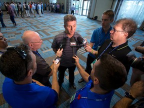 Toronto Blue Jays interim general manager Tony LaCava, center, speaks to members of the media after attending the baseball general managers' meetings, Wednesday, Nov. 11, 2015, in Boca Raton, Fla. (AP Photo/Wilfredo Lee)