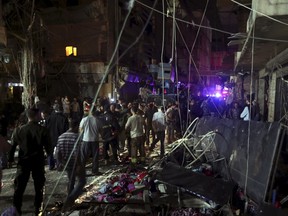 Residents inspect a damaged area caused by two explosions in Beirut's southern suburbs, Lebanon November 12, 2015. At least 27 people were killed in two suicide explosions in a busy area in Beirut's southern suburb, a stronghold of Lebanese Hezbollah, on Thursday, medical officials said. REUTERS/Hasan Shaaban