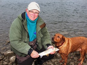 Emmerson Dober, Neil’s fishing dog Penny and a Red Deer River mountain whitefish. (NEIL WAUGH/EDMONTON SUN)