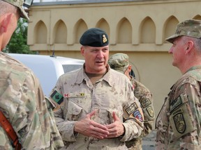 Colonel Migaleddi, US Army (right) greets Major General Dean Milner (centre), Canadian Contribution to the Training Mission in Afghanistan in Kabul, Afghanistan on August 12, 2013 during Operation ATTENTION.  MCpl Frieda Van Putten