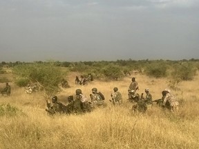 Nigerian army soldiers wait in position as they attack a Boko Haram position. (REUTERS/Stringer)
