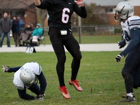 Cody Jones of the Northern Vikings tosses the ball as a pair of Ursuline College Lancers close in on him during the Lambton Kent senior boy's high school football semifinal in Sarnia Thursday afternoon. The Vikings won 37-0 to advance to the championship. (Terry Bridge, The Observer)