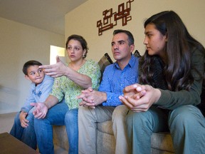 Johanna Regalado describes how her husband, Edgar, was shot at by a man on a motorcycle in Colombia after he denied a FARC member a bank loan while sitting with their son, Juan, 8, and daughter, Laura, 13, in their apartment in London, Ont. on Thursday November 12, 2015. The family left Colombia over two years ago. (CRAIG GLOVER< The London Free Press)