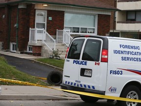 Police at the scene Nov. 12, 2015, a day after the slaying of Stella Tetsos, 82, in her home. (Veronica Henri/Toronto Sun)