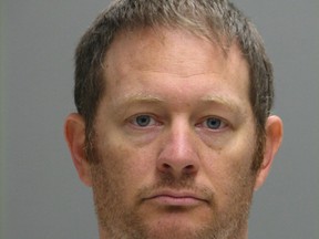 This booking photo provided by the Delaware Department of Justice shows Lee Robert Moore. Federal authorities say Moore, a Secret Service agent from Maryland, sent obscene images and texts to someone he thought was a young Delaware girl, sometimes doing it while on duty at the White House. (Delaware Department of Justice via AP)