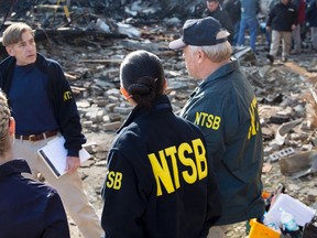 Officials from the National Transportation Safety Board (NTSB) investigate the scene of a deadly plane crash in Akron, Ohio, November 11, 2015.  A pilot on a 10-passenger Hawker business jet made no distress calls before a fiery crash in Ohio on Tuesday that killed all nine people on board, investigators said on Wednesday.  REUTERS/NTSB/Handout via Reuters