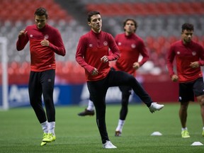 Canadian men’s national team midfielder Will Johnson (centre) and his teammates stretch during practice in Vancouver yesterday. Canada plays Honduras tonight in the second-last round of qualifying for the 2018 World Cup in Russia. (THE CANADIAN PRESS/PHOTO)
