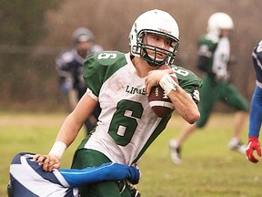 Quinte defender Logan Bradshaw tackles Adam Scott ballcarrier Daniel Challice during COSSA AAA senior football final Thursday at QSS. (Isaac Paul for The Intelligencer)