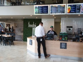 Rachel Merry serves a customer at Freshii in London. A Freshii is now open in Val Caron. (DEREK RUTTAN, The London Free Press)